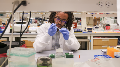 male scientist doing lab work at a bench