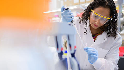 Female Scientist using a pipette