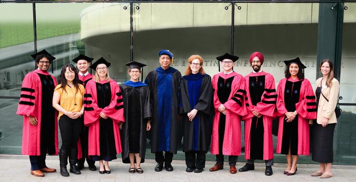 DMS faculty standing with students at graduation