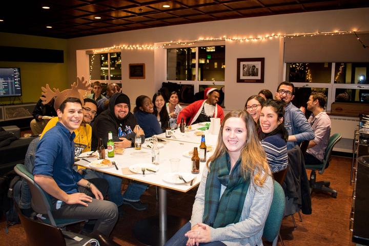 MSBH students sitting around a table for a holiday celebration