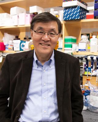 Kim Kwang Soo standing in lab